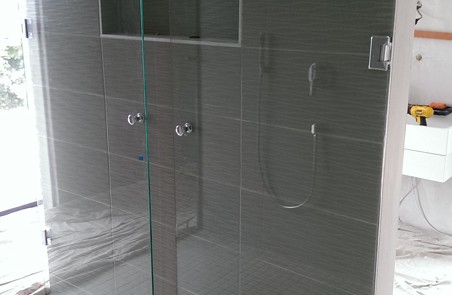 Fold away shower screen